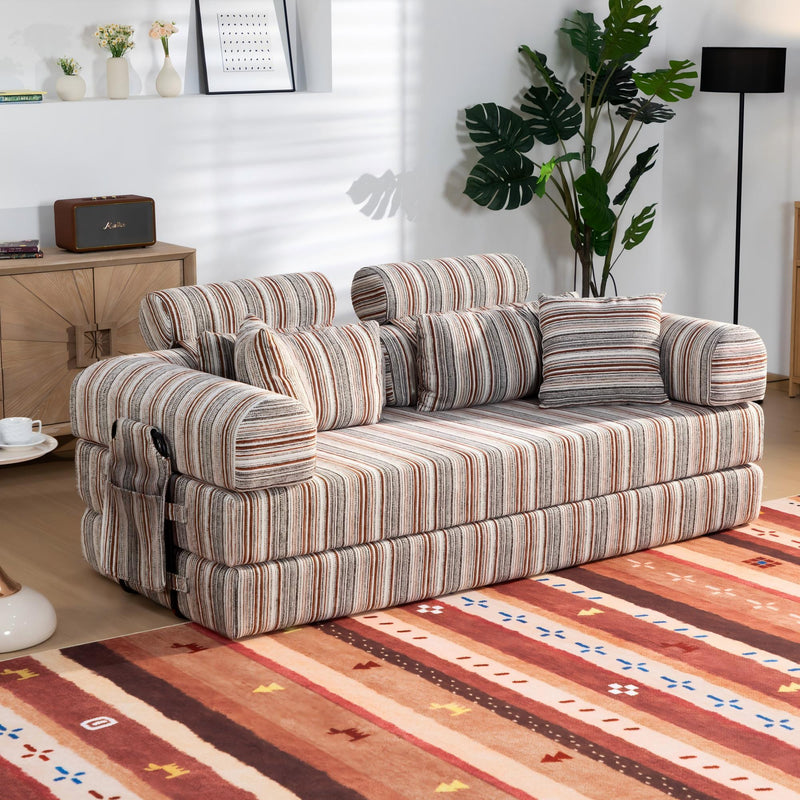Sleeper sofa bed with striped upholstery and bundled back cushions, lounge-ready angle