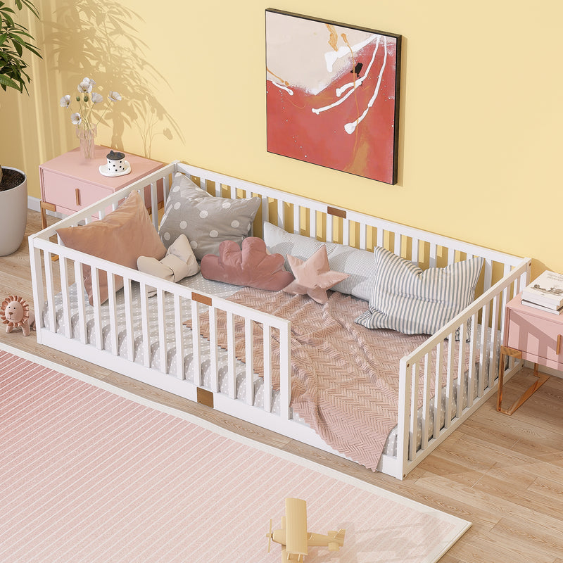 White twin floor bed with tall safety guardrails, wooden slats; styled with bedding.