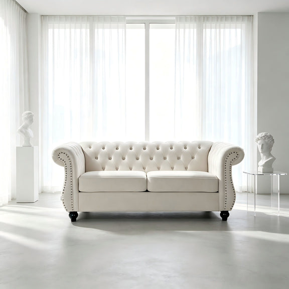Beige tufted button loveseat with rolled arms and studded nailhead trim, two-seat design.