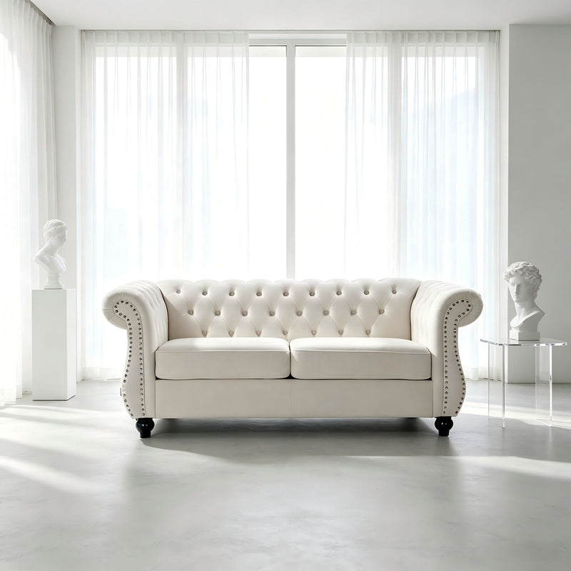 Beige tufted button loveseat with rolled arms and studded nailhead trim, two-seat design.