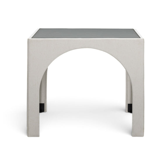 Beige upholstered game table with arched cutout and dark corner feet