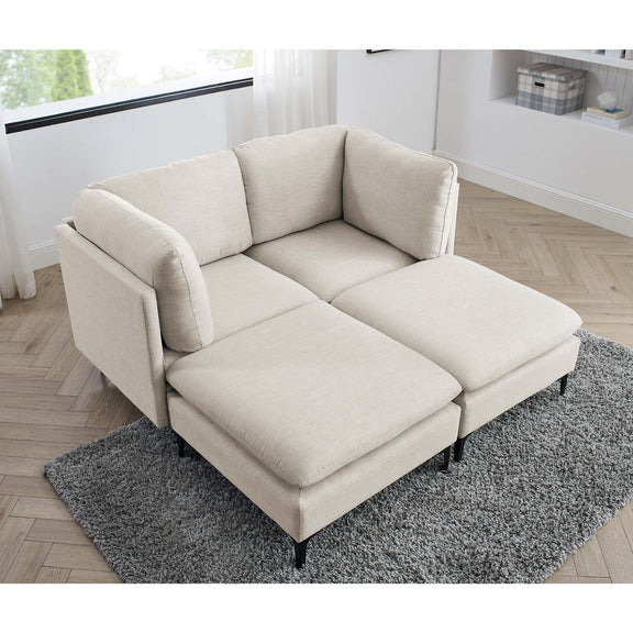 Beige sectional chaise sofa with tall black legs and gray area rug