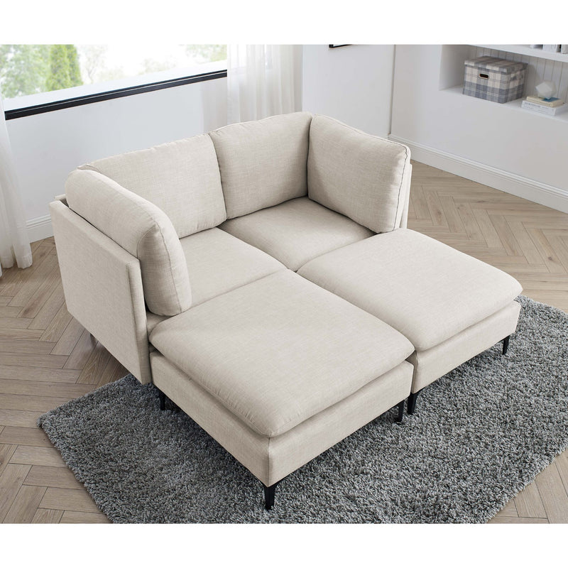 Beige sectional chaise sofa with tall black legs and gray area rug