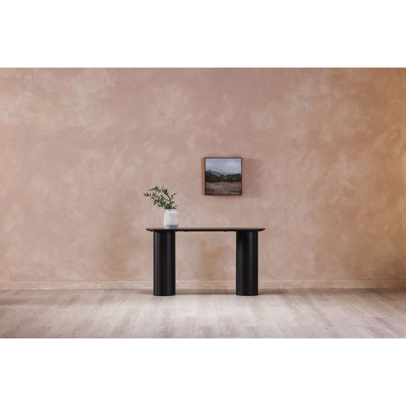 Black console table with oval top and two fluted pedestal legs