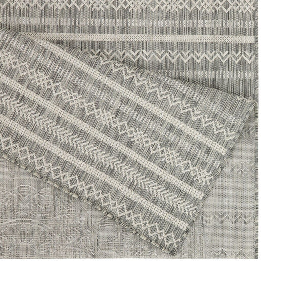 Indoor/outdoor polypropylene rug corner with gray and white striped woven pattern