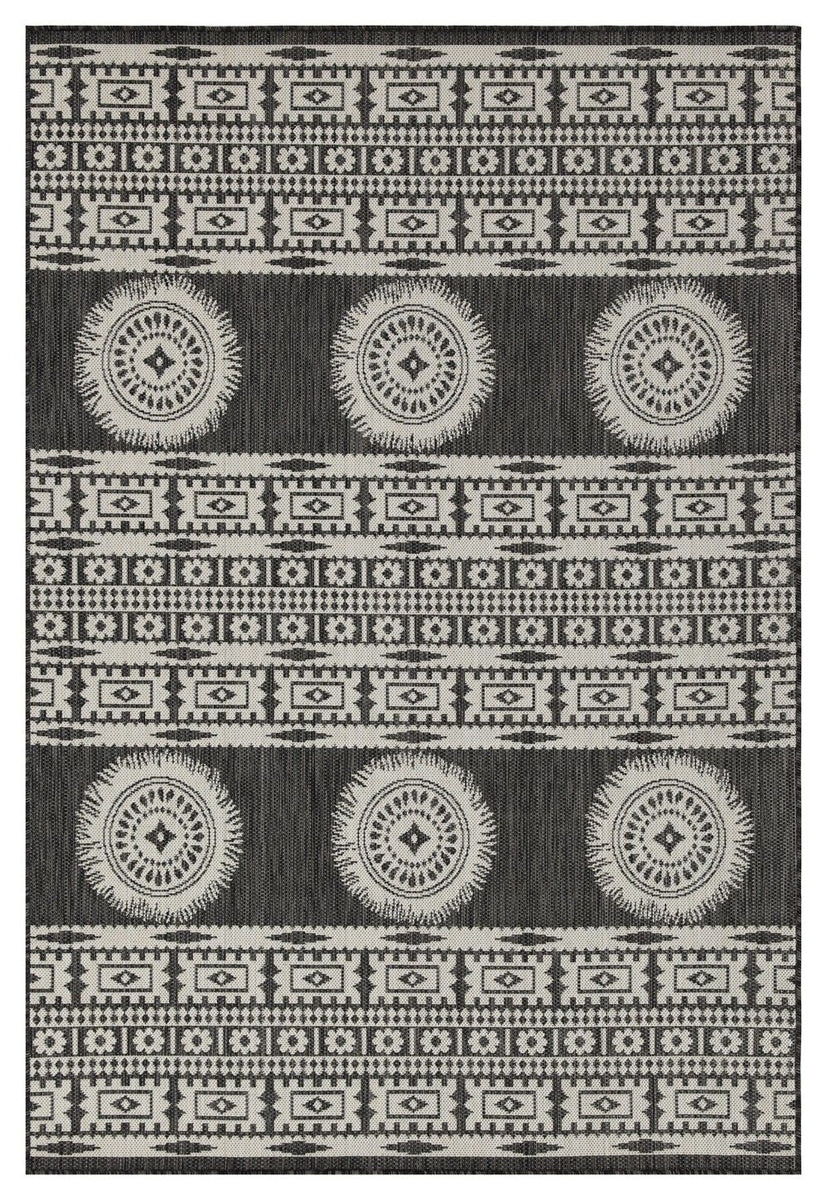 Dark gray polypropylene area rug with white tribal stripes and medallion circles