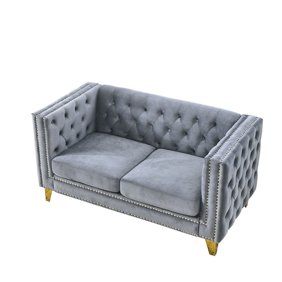 Light gray button-tufted loveseat with studded trim and gold-toned corner legs