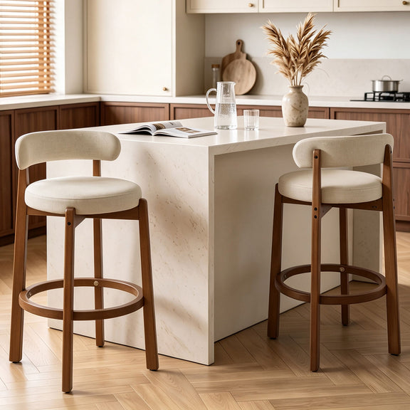 Pair of beige bar stools with rounded seats, curved backs, walnut legs, and ring footrests