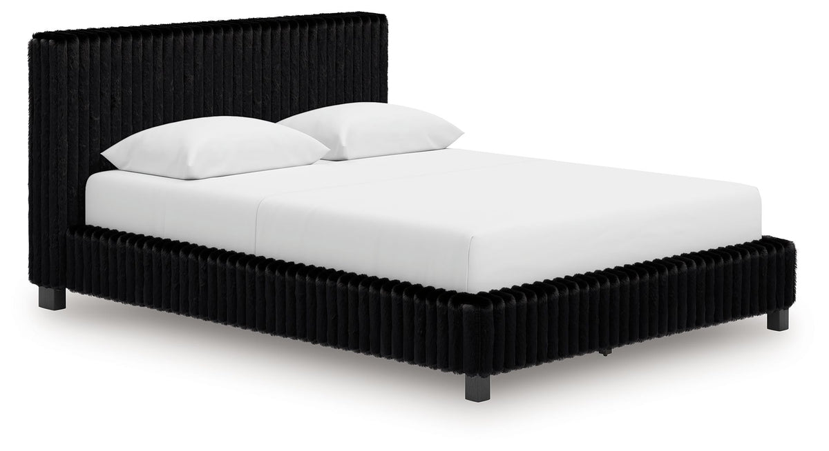 Black upholstered bed with ribbed headboard, squared sides, and white bedding.