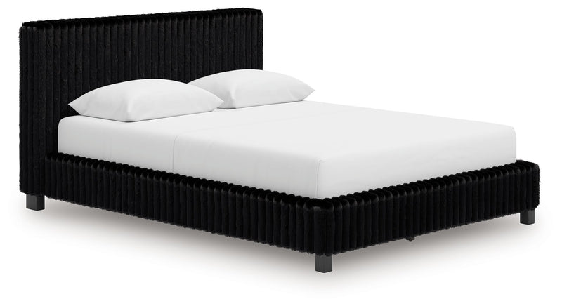 Black upholstered bed with ribbed headboard, squared sides, and white bedding.
