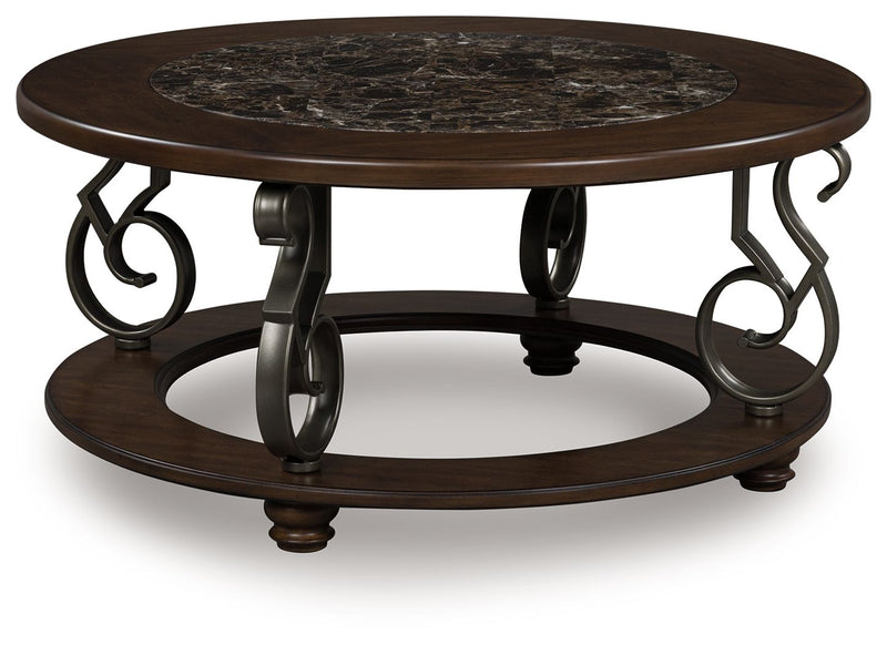 Dark brown round cocktail table with stone-look top, lower shelf, scroll metal legs