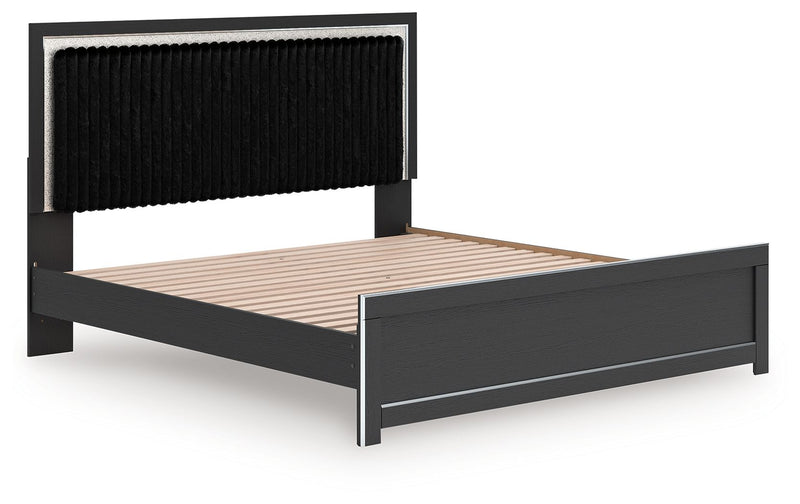 Dark upholstered bed frame with ribbed headboard, slatted platform, and matching footboard