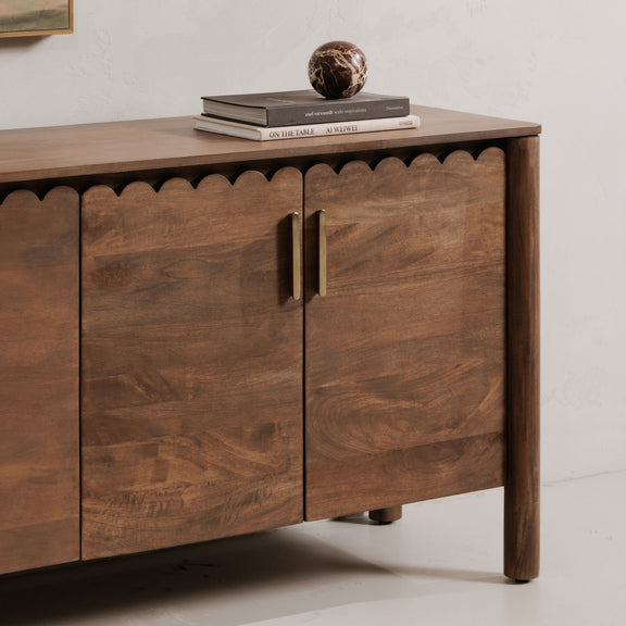 Vintage brown sideboard with two-panel doors, vertical metal handles, and scalloped trim