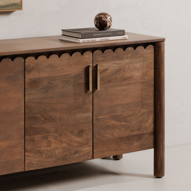 Vintage brown sideboard with two-panel doors, vertical metal handles, and scalloped trim