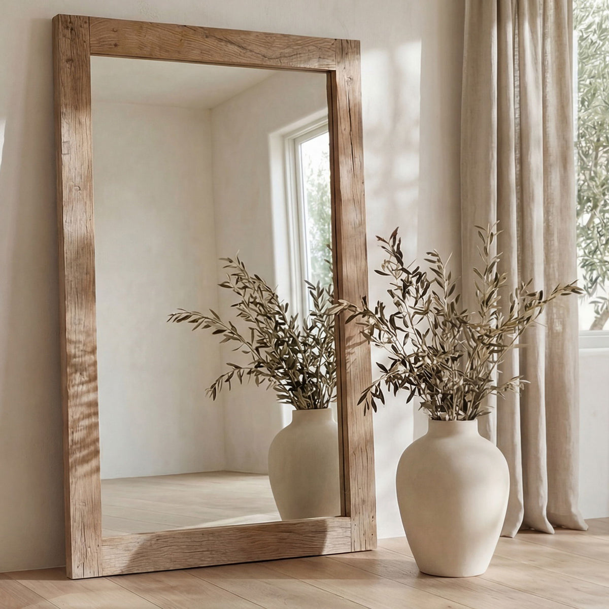 Reclaimed wood floor mirror with rectangular frame, natural grain, standing beside vases