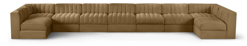 Light brown velvet modular sectional sofa with tufted cushions and curved armrests