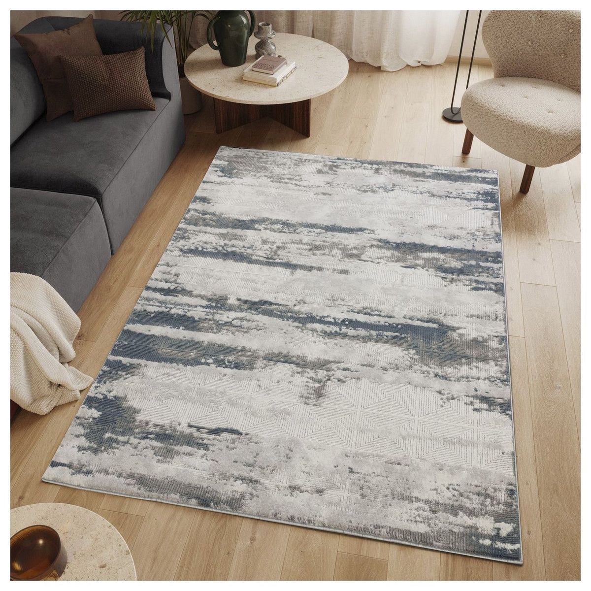 Rectangular gray and blue area rug with distressed horizontal stripe pattern