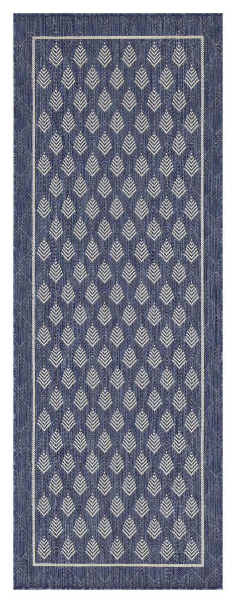 Blue area rug with ivory diamond and arrow pattern, bordered edge