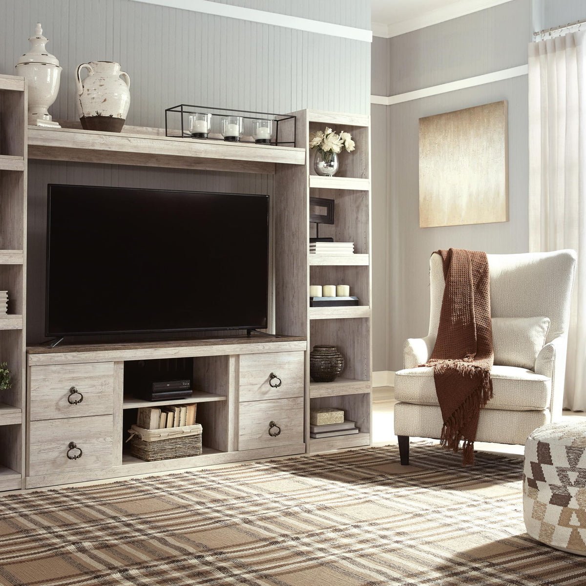 Whitewash entertainment center with TV opening, drawers, and side bookcase shelves