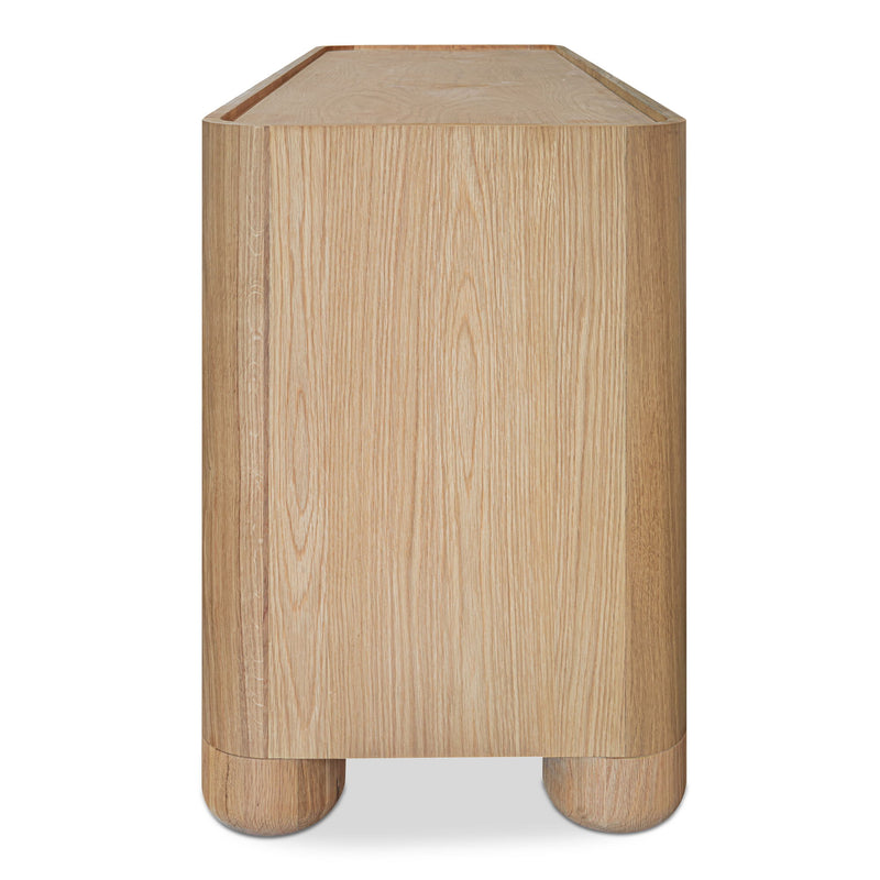 Side view of the light brown Gibson dresser, showing its wood grain and rounded feet