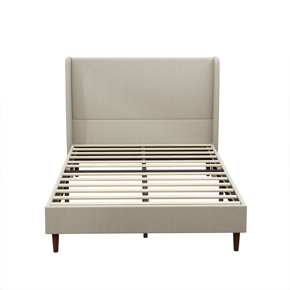 Beige upholstered bed with a tall panel headboard, wood legs, and slatted base