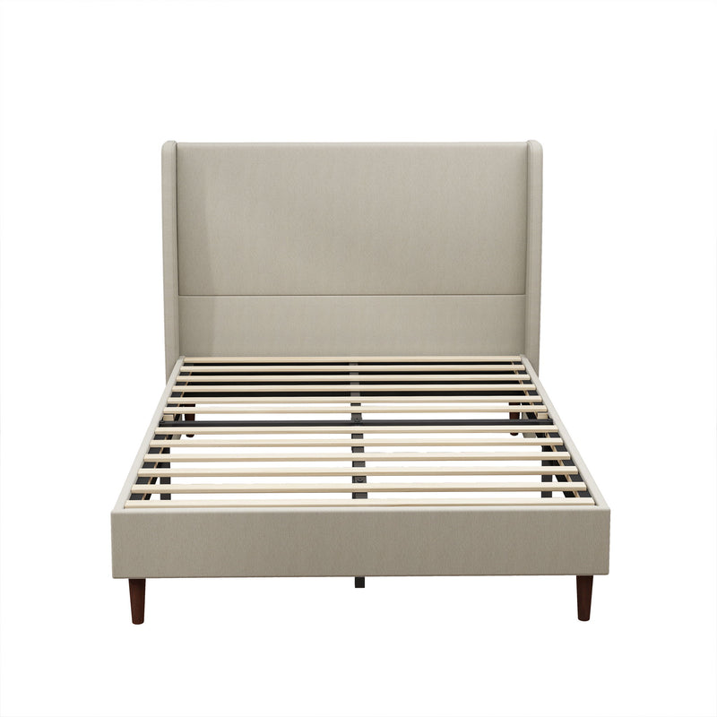 Beige upholstered bed with a tall panel headboard, wood legs, and slatted base