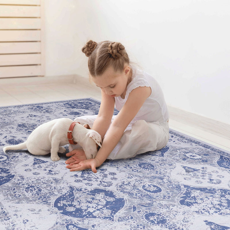 Blue and white ornate area rug with distressed circular medallion pattern and border