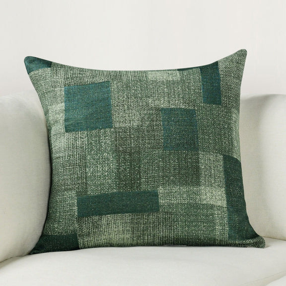 Viridian green square throw pillow with distressed patchwork checks on textured fabric