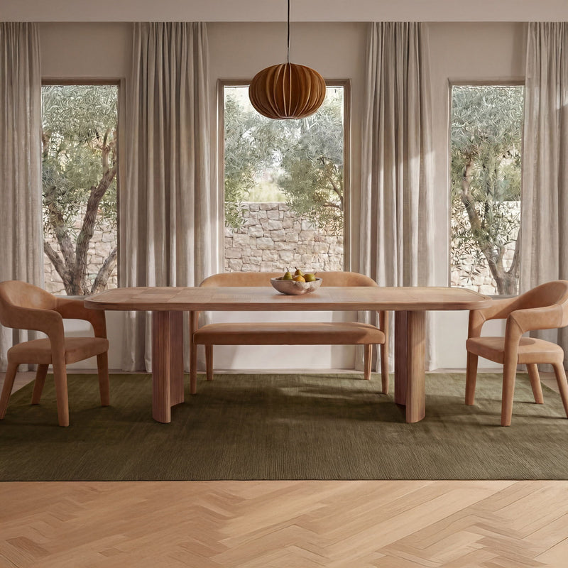Tan leather dining bench along wooden dining set with upholstered chair