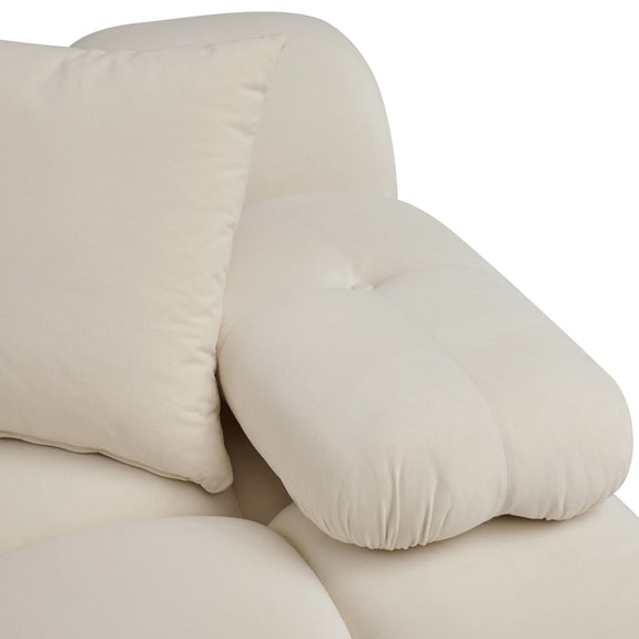 Close-up of cream sofa cushion with padded seams and soft rounded edges