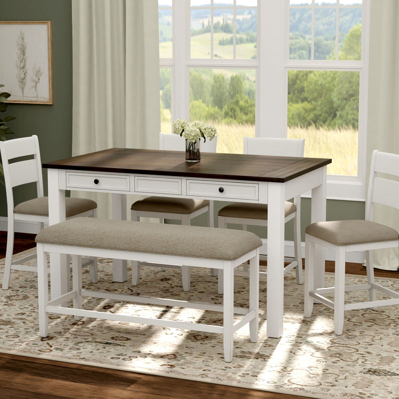 White dining table with dark top, beige bench seat and two matching chairs