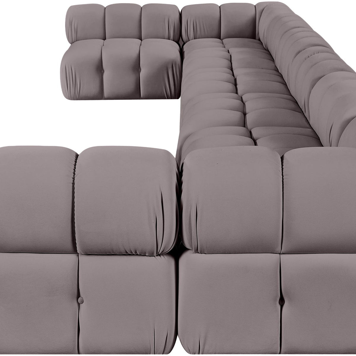 Gray modular sectional sofa with tufted cushions and rounded chaise corner