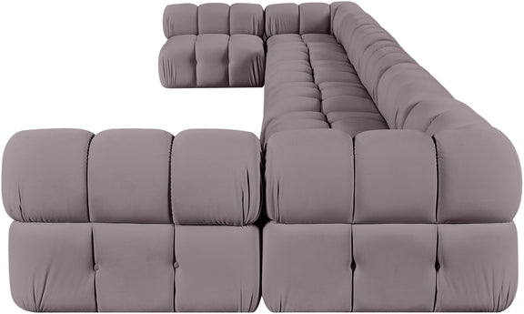 Gray modular sectional sofa with tufted cushions and rounded chaise corner
