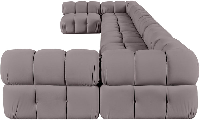 Gray modular sectional sofa with tufted cushions and rounded chaise corner