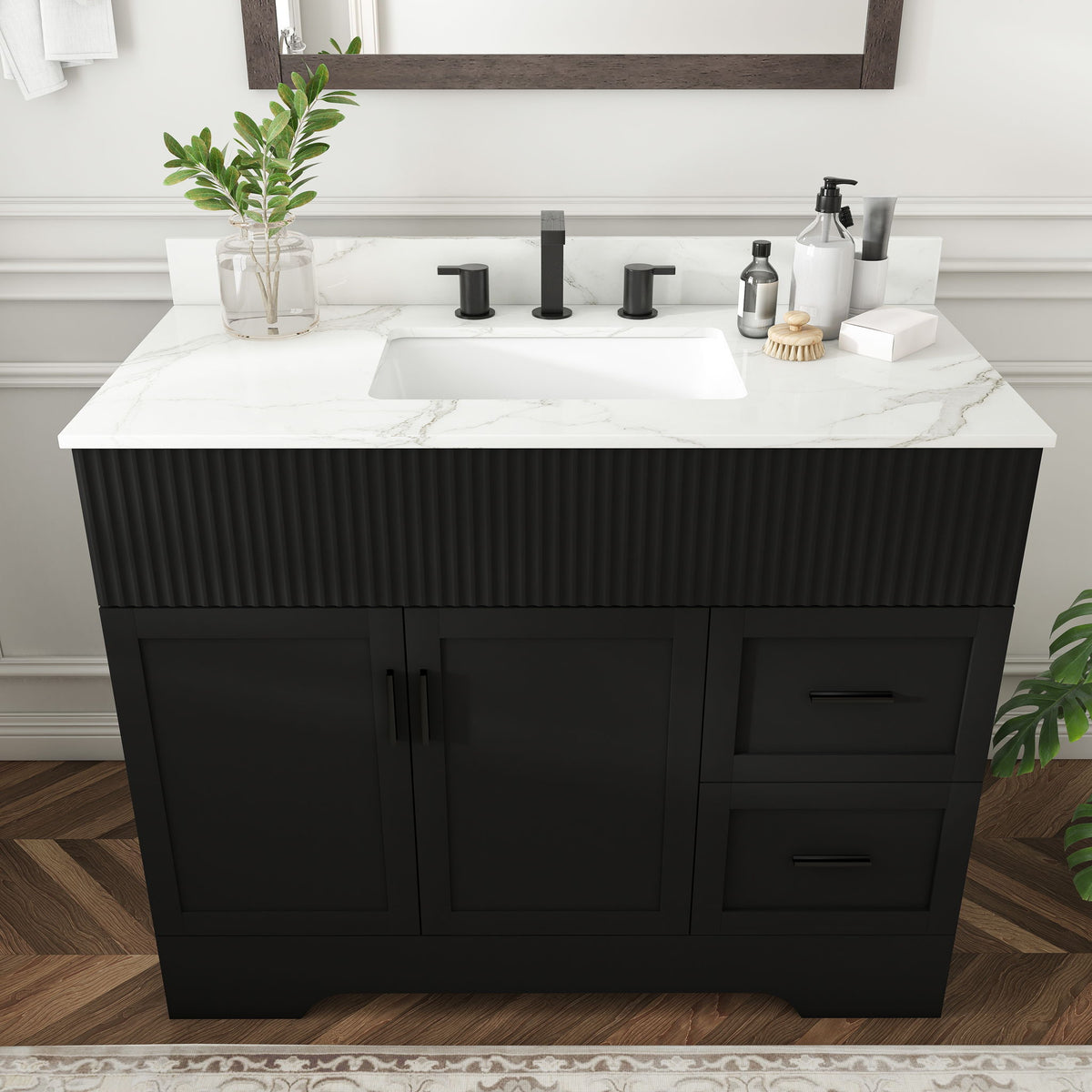Black bathroom vanity with white countertop sink, three faucet holes, fluted cabinet