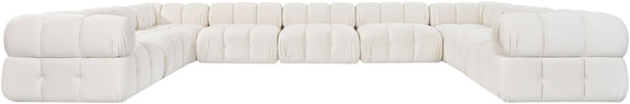 White velvet sectional with tufted cushions, L-shaped chaise, and rounded arms