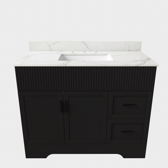 Black bathroom vanity cabinet with white sink and fluted front panel