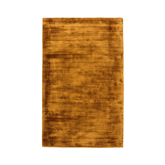 Ochre distressed area rug with flat, low-pile texture