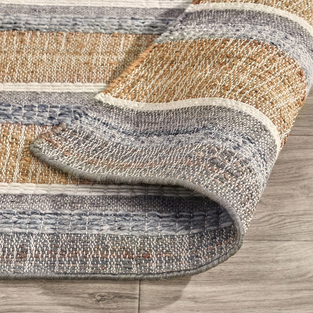 Coronado rug corner close-up showing striped weave and stitched border edge
