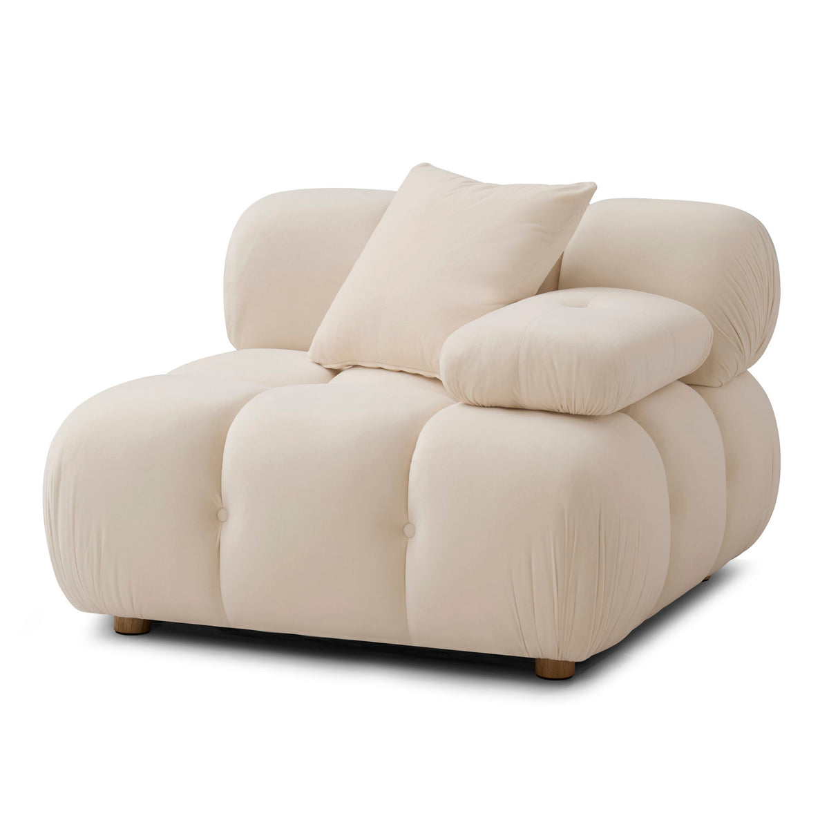 Light cream corner chair with layered pillows, rounded arms, and tufted cushion panels