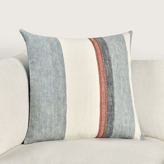 Blue and cream striped throw pillow with rust-red trim band, close-up
