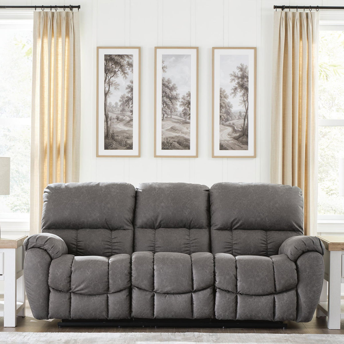 Dark gray reclining sofa with adjustable headrests and plush, tufted seat and back cushions