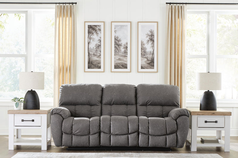 Dark gray reclining sofa with adjustable headrests and plush, tufted seat and back cushions