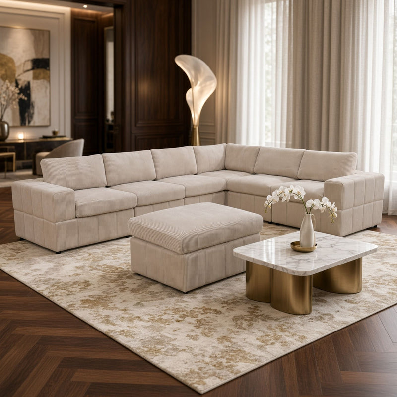 Beige L-shaped sectional sofa and matching ottoman with wide cushioned seats.