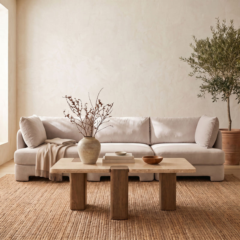 Velvet upholstered 3-piece sofa with light upholstery, three seat cushions, and back pillows