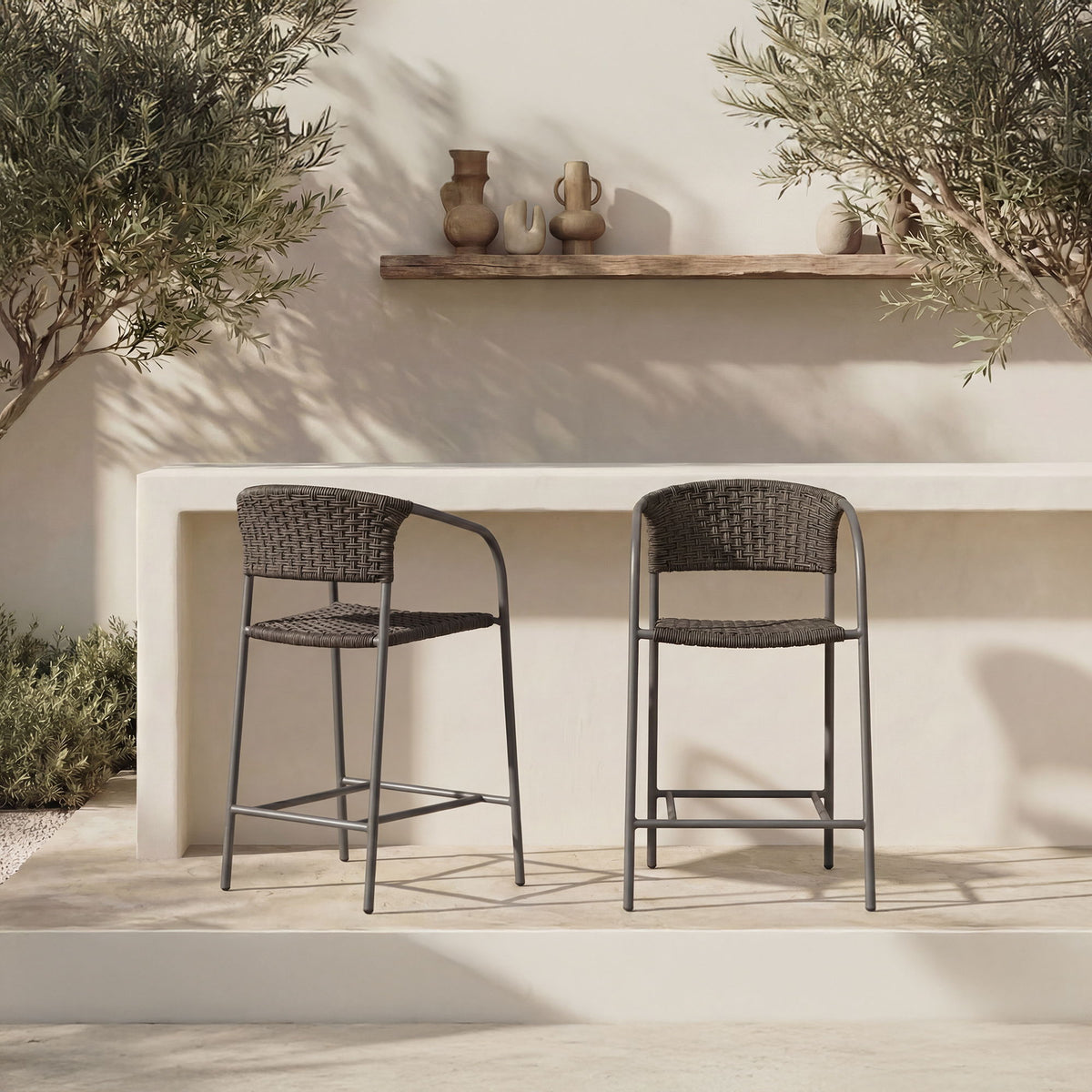 Set of two outdoor counter chairs with dark woven seats and backs, black metal frames