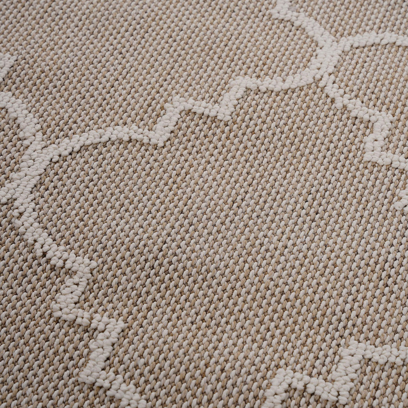 Beige textured rug surface with raised trellis pattern in a soft loop weave.