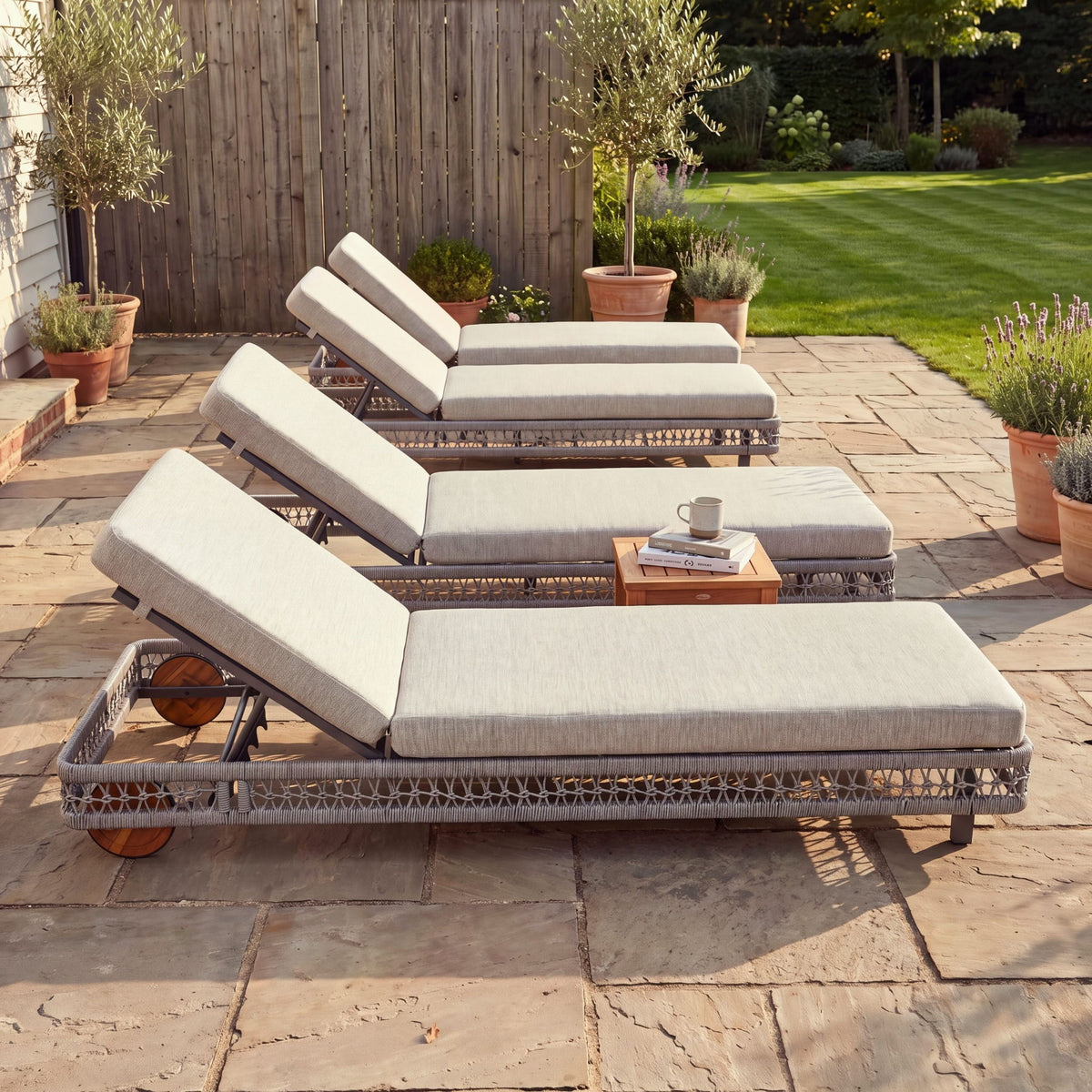 Set of gray outdoor chaise lounges with adjustable backrests and rolling wheels