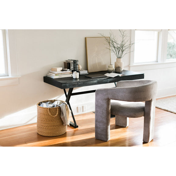 Black ash desk with tabletop items and X-frame legs