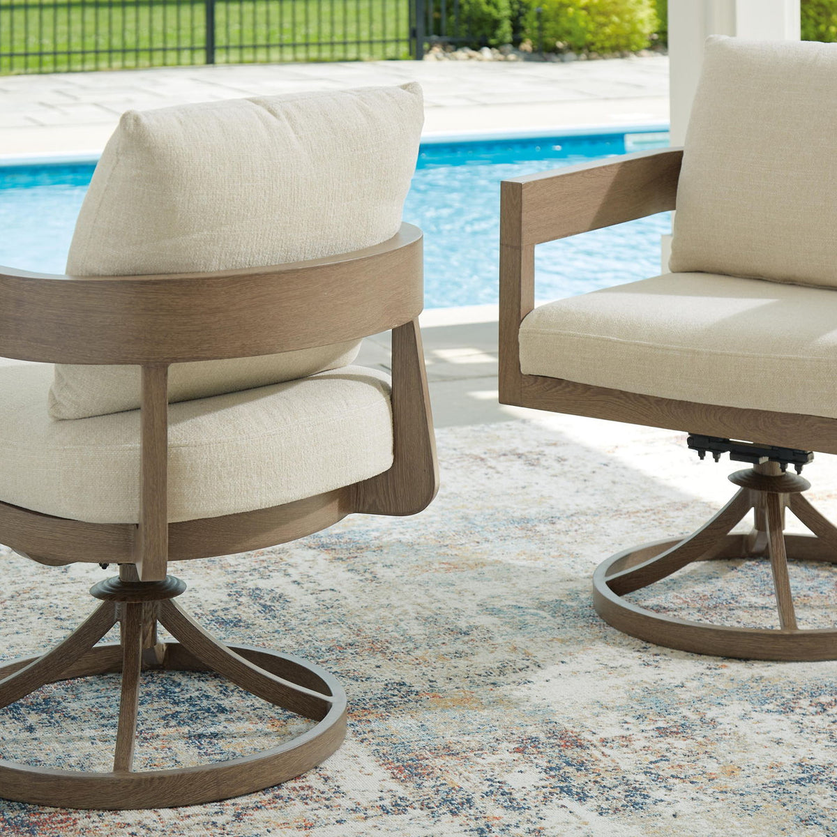 Swivel patio chair with beige cushion on dark brown circular pedestal base